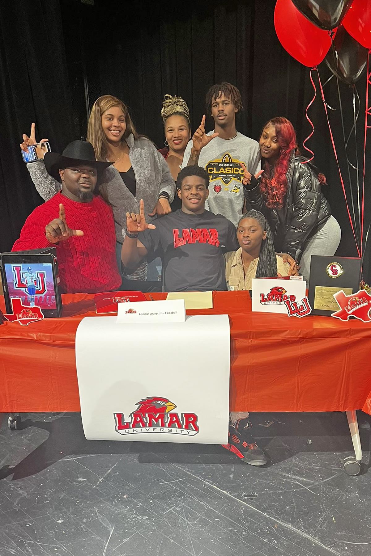 Cypress Springs High School senior Lonnie Leary, seated center, poses with his family after signing his letter of intent.